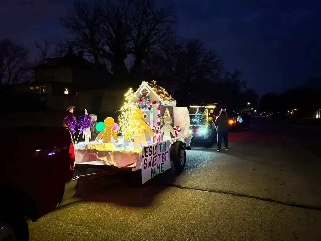 The church Christmas parade float lit up at night